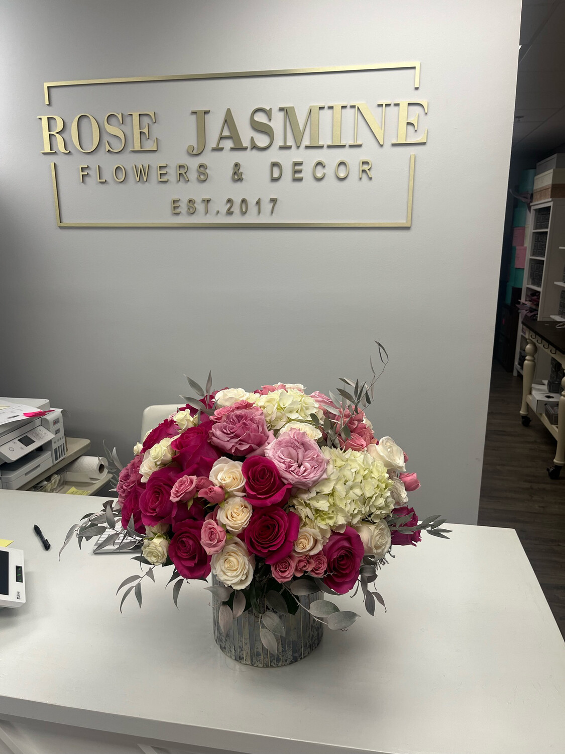A Mixture Of Premium Cut Roses And Hydrangeas In A Designer Vase