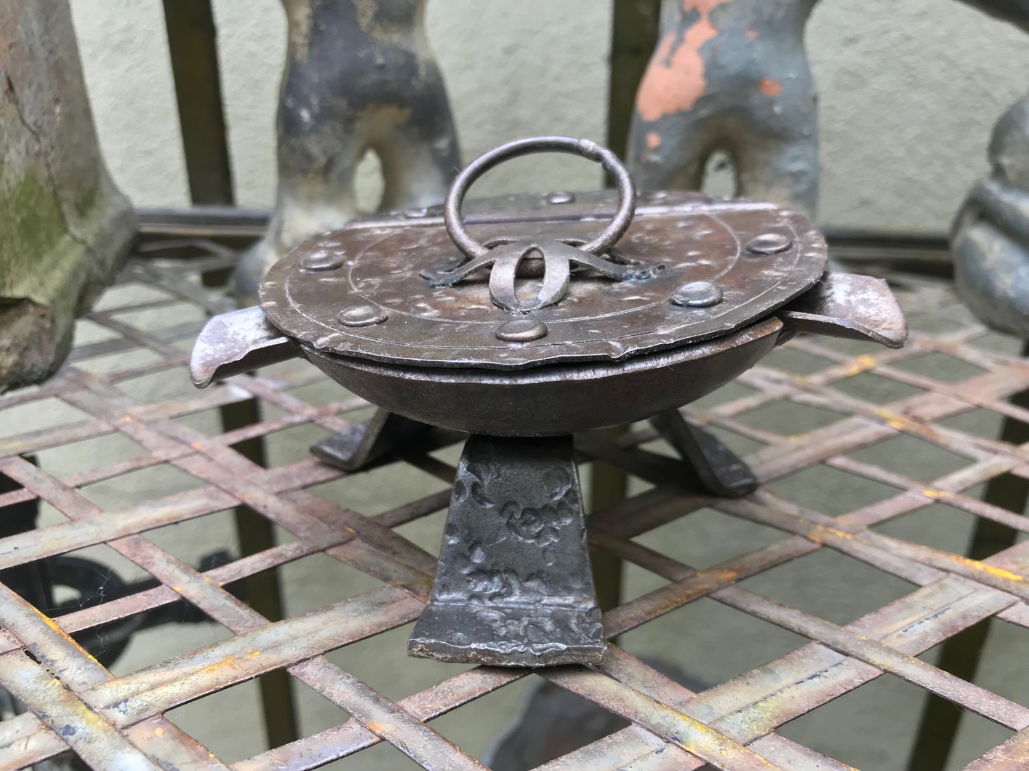 Prachtige zelfgemaakte decoratieve ijzeren asbak op pootjes