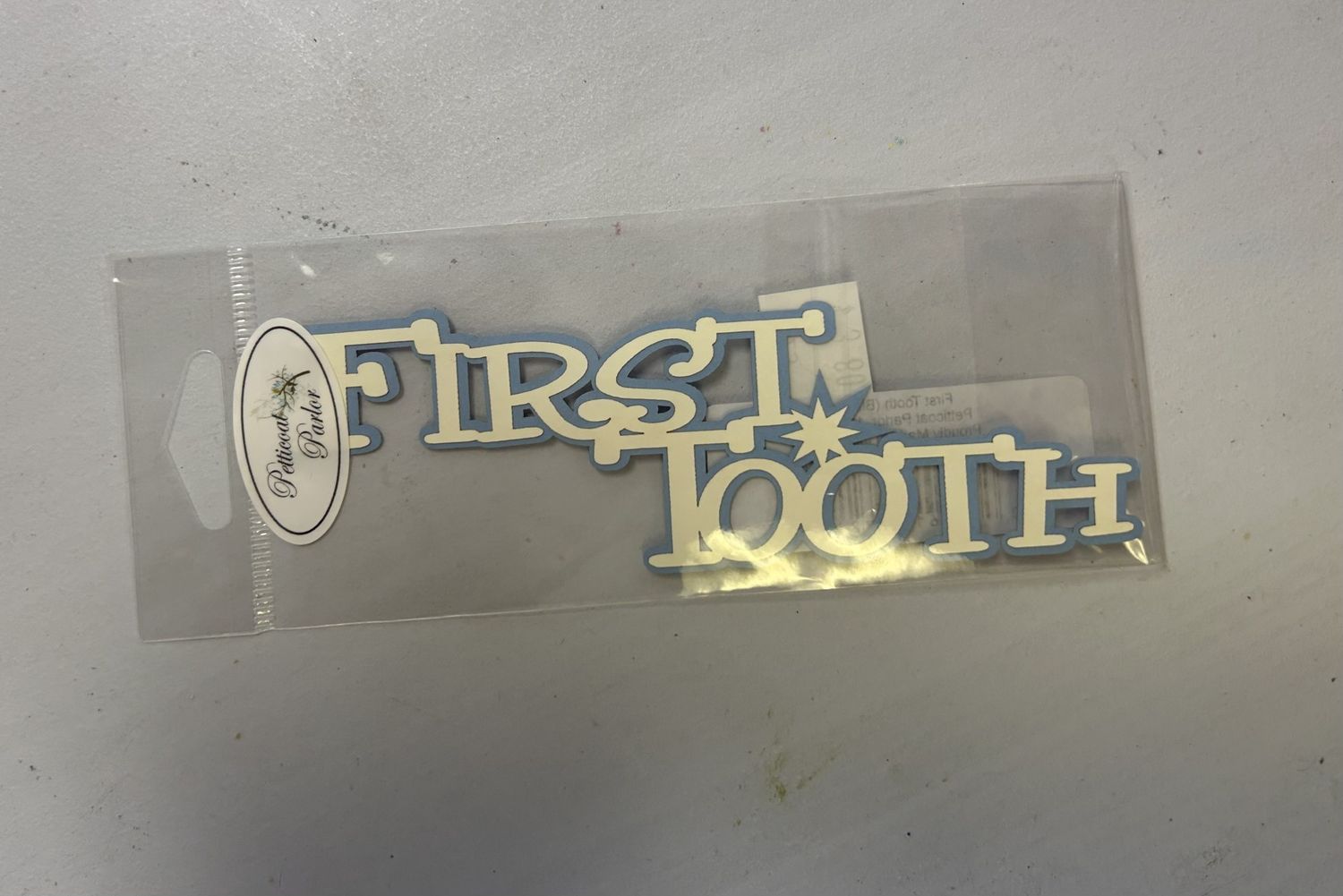 First Tooth (White on Pale Blue)