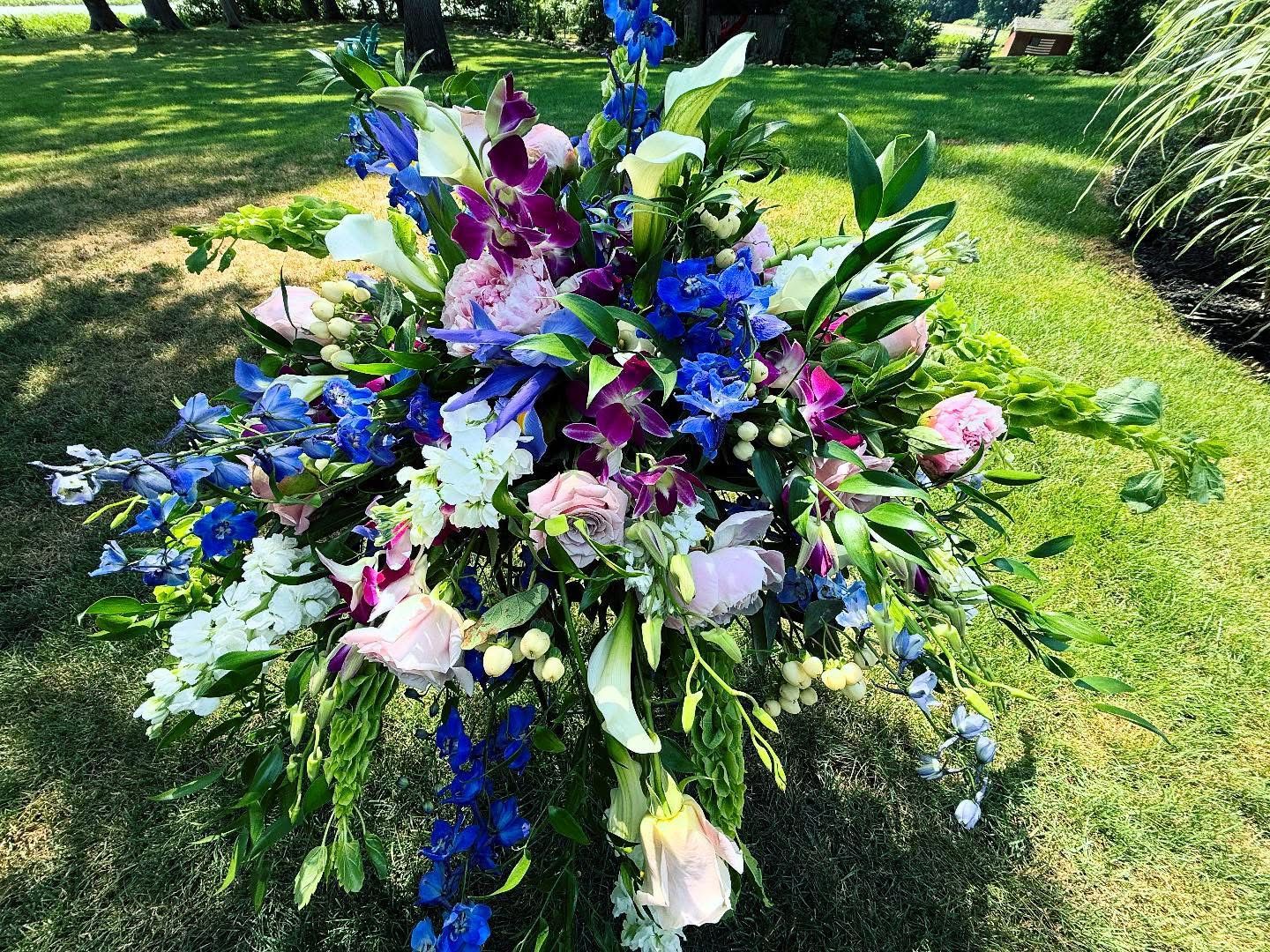 Bold Garden Casket Spray by Twigs Floral Design