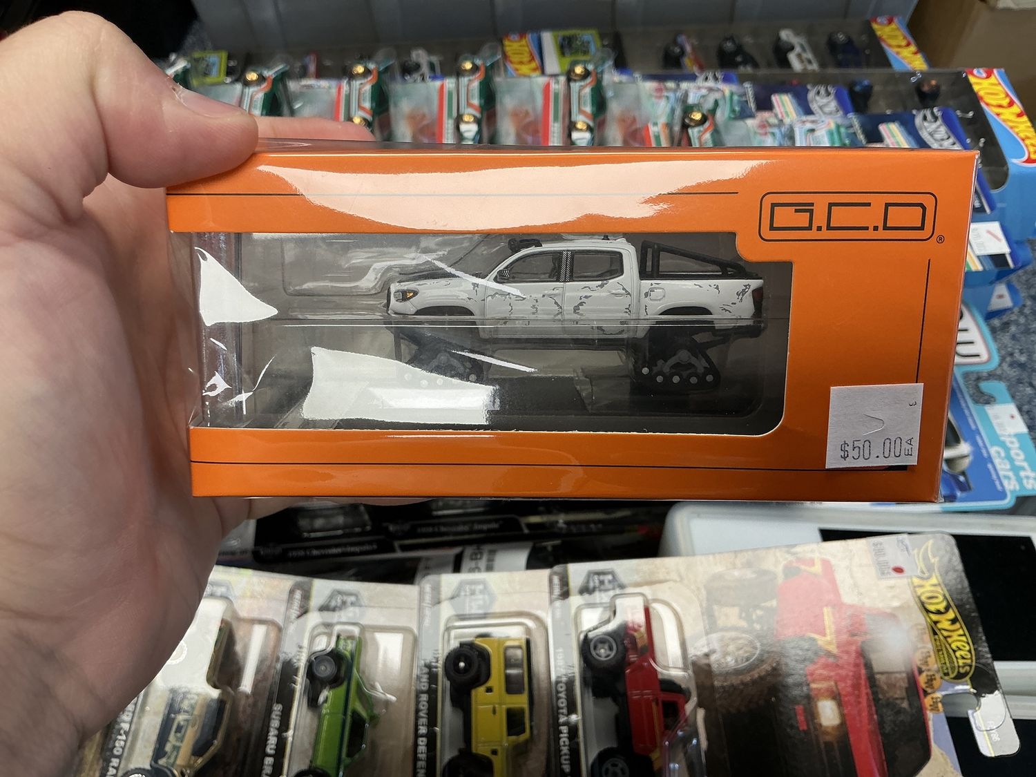Toyota Tacoma white w/snow tracks