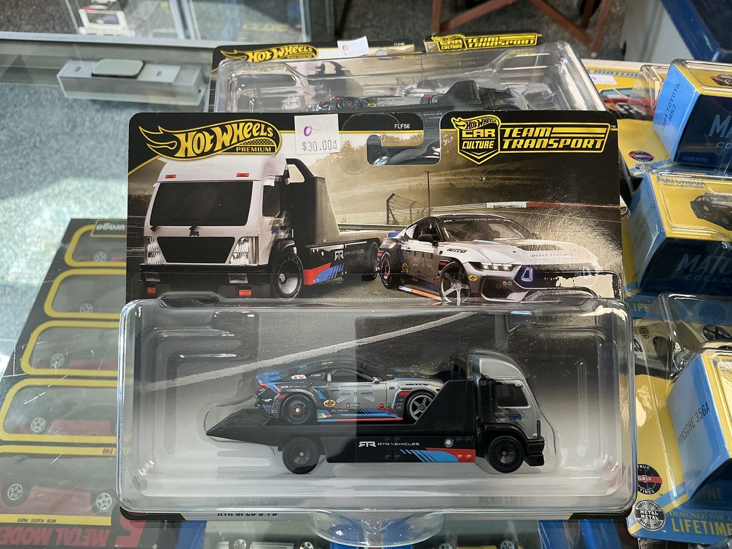 Team transport number 90 2024 Ford Mustang with arrow lift