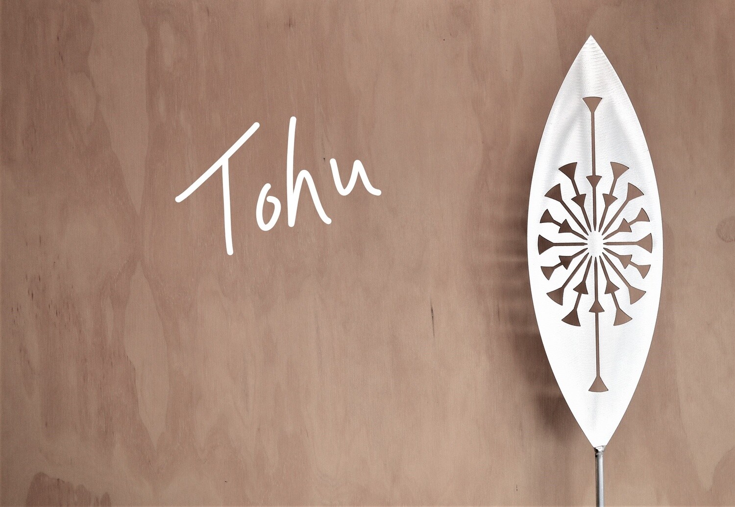Tohu Aluminium Spear by Grounded Art NZ in a gallery setting where the shadows are cast onto the pale plywood wall behind.