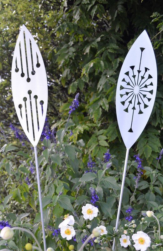 Reflection and Tohu designs in Grounded Art NZ Aluminium garden spears in an established New Zealand garden.