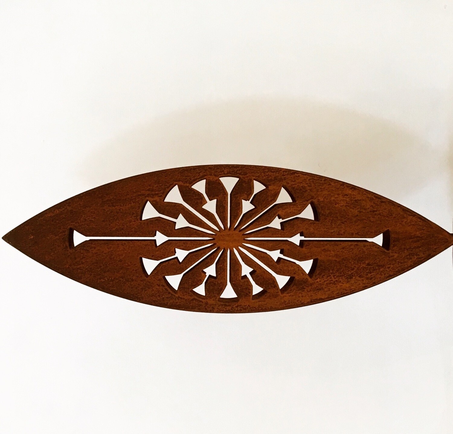 Tohu design on its side. A Grounded Art NZ rusty Corten sculpture with bold, dandelion like pattern.