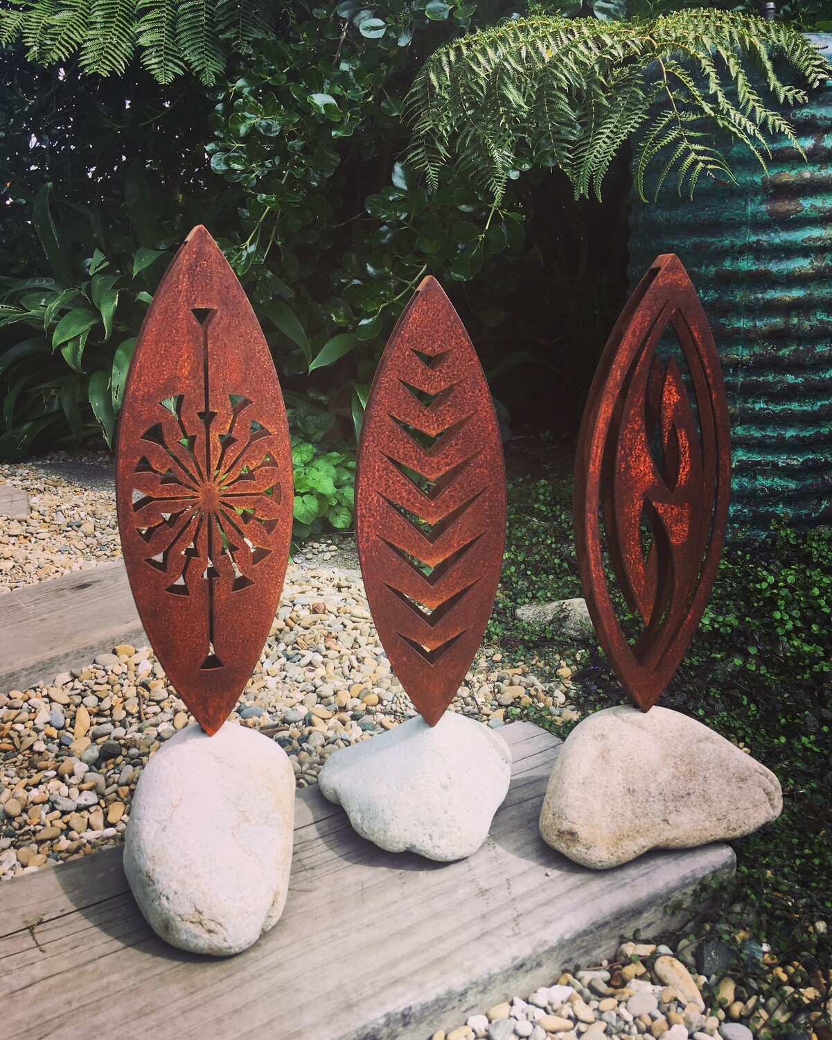 3 Corten metal sculptures by Grounded Art NZ in stone bases. Tohu, Arrow and Fish Hook design.