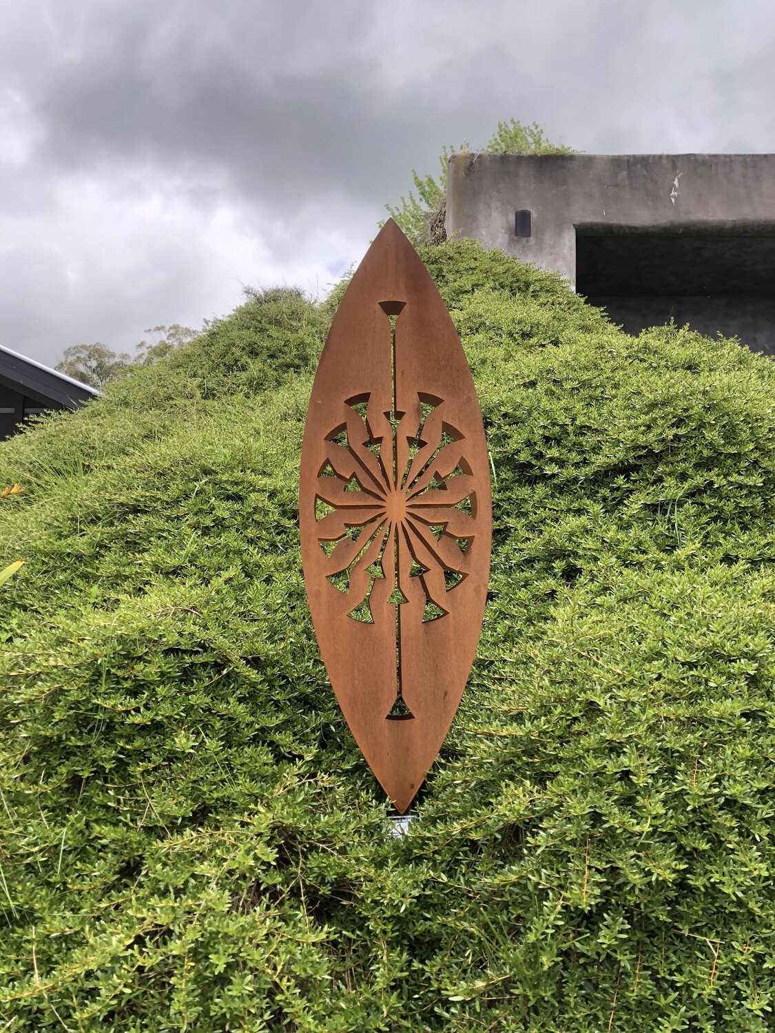 Large 3D Corten Sculpture in Grounded Art NZ's Tohu design located in amongst lush green Native NZ bush.