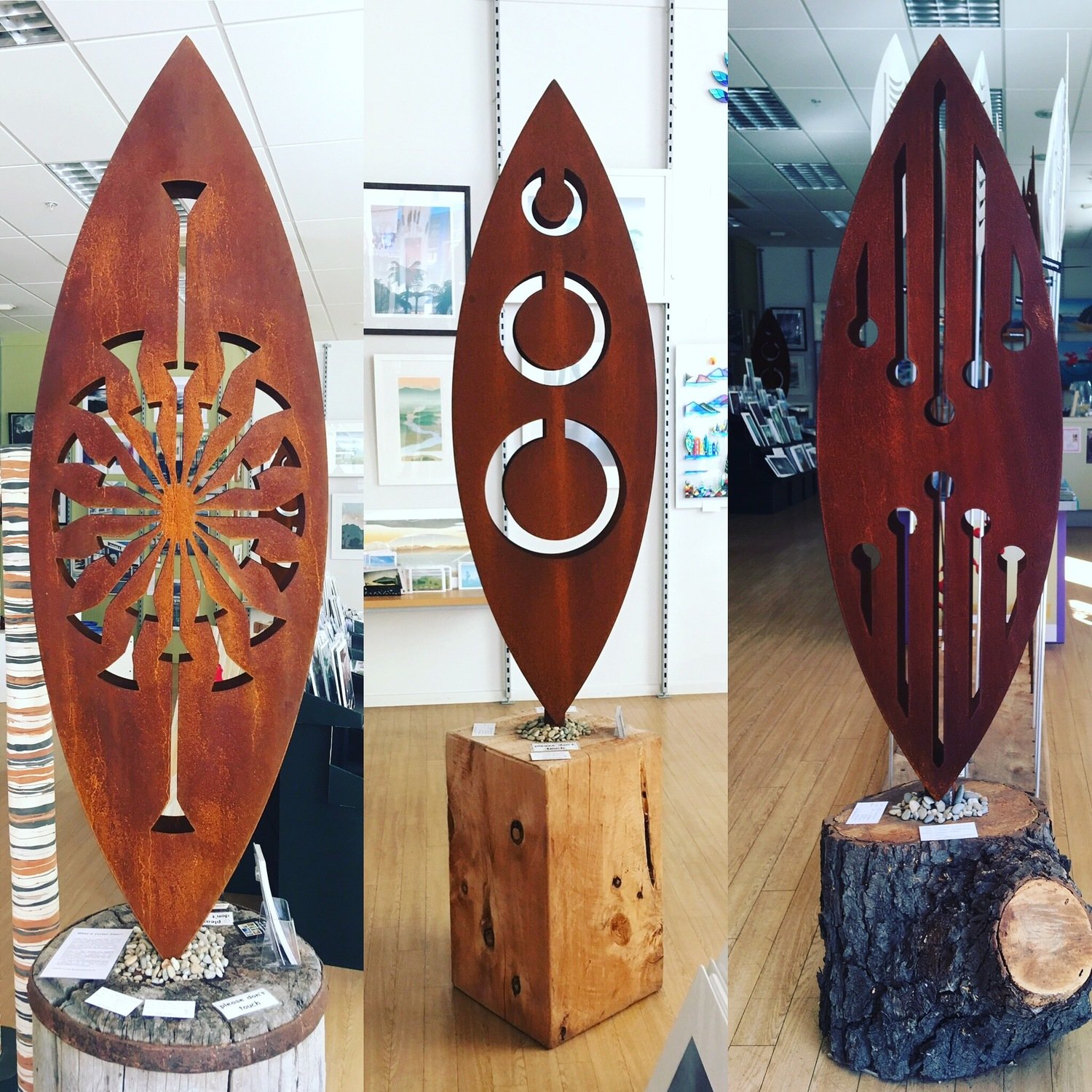 Gallery display of 3 large 3D Corten Sculptures by Grounded Art NZ. Tohu, Tribal, Reflection designs in Arty Nelson Gallery.