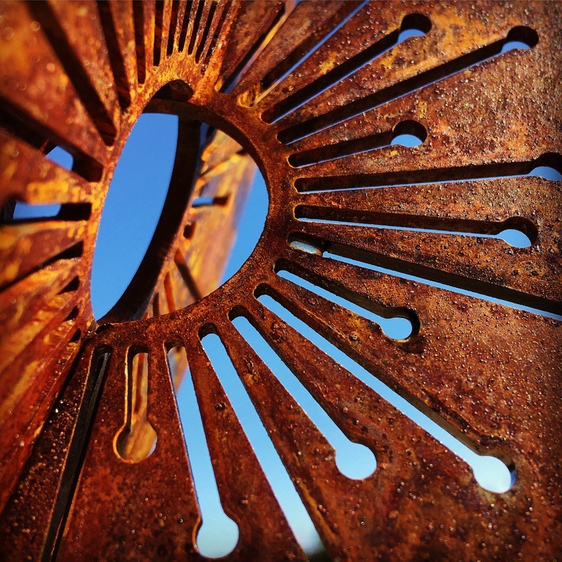 Detailed close up of Corten Allium wands by Grounded Art NZ showing the fine floret details of the Allium globe. 