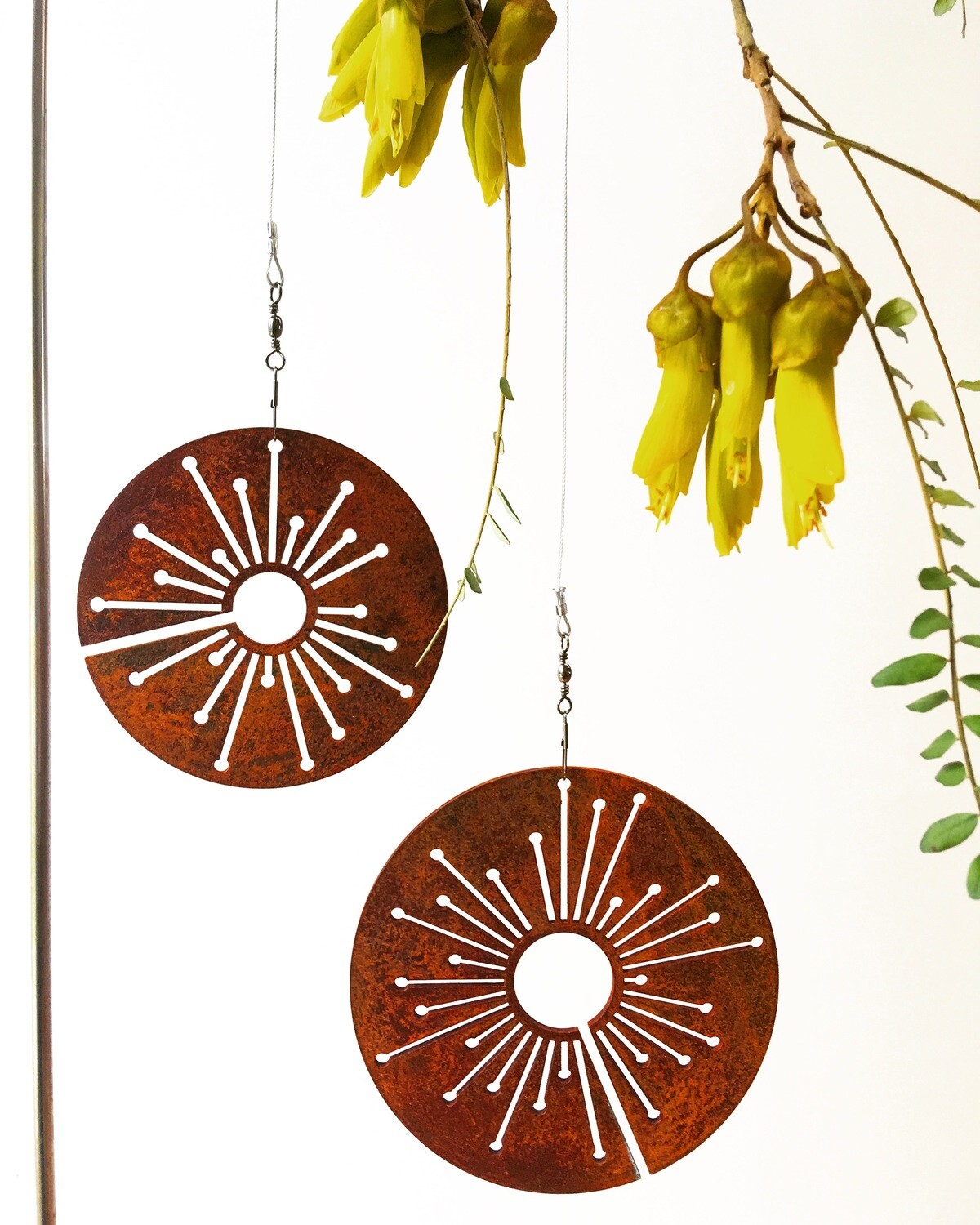 Corten Spinning Alliums by Grounded Art NZ. Garden Art with rusty patina suspended from swivels for movement and interest. 
