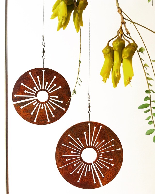 Corten Spinning Alliums by Grounded Art NZ. Garden Art with rusty patina suspended from swivels for movement and interest. 