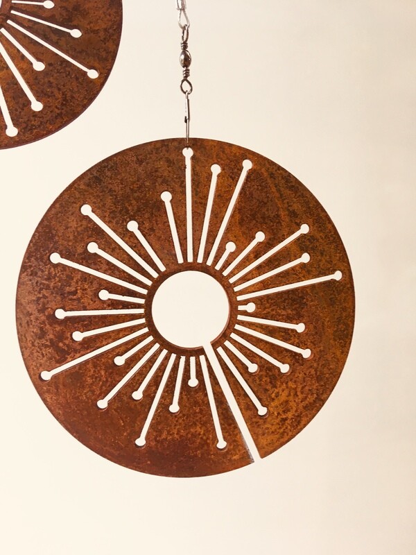 Corten Spinning Allium by Grounded Art NZ. Garden Art with rusty patina suspended from swivels for movement and interest. 