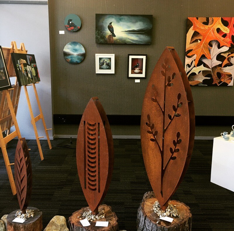 3D rusty Corten Korokio Sculpture in Arty Nelson Gallery next to our Nikau design. Sculptures proudly made by Grounded Art NZ