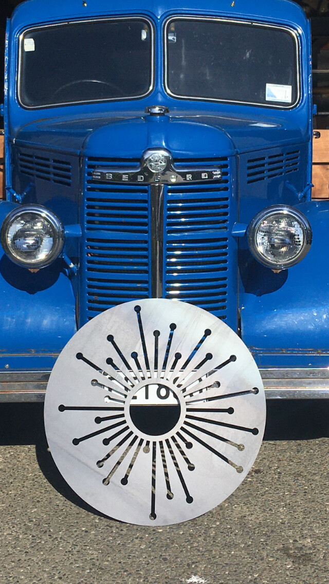 Grounded Art NZ's clean Corten Allium Wall Art leaning up on their 1950 Blue K Bedford delivery truck. South Otago, NZ.