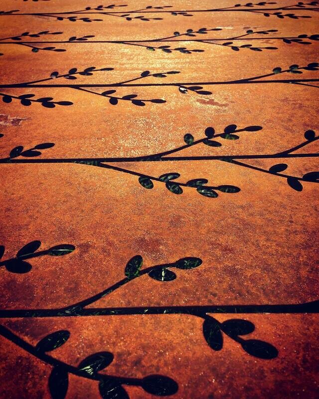 Close up of Grounded Art NZ's Korokio Corten Screen. Warm rusty patina of these privacy screens look good in lush NZ gardens.