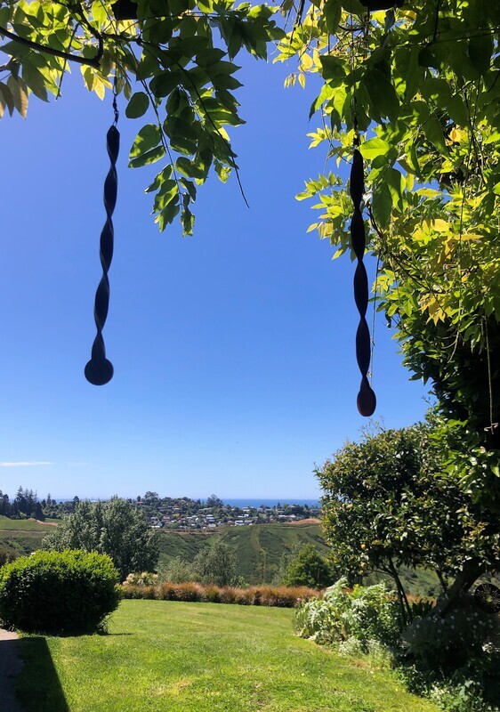 Corten Miro by Grounded Art NZ of Otago. Small metal garden art with a twisted Corten design that spins, twirls and twists.