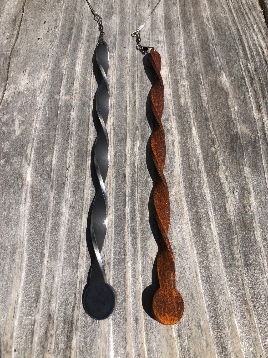 Corten Miro by Grounded Art NZ of Otago. Small metal garden art with a twisted Corten design that spins, twirls and twists.