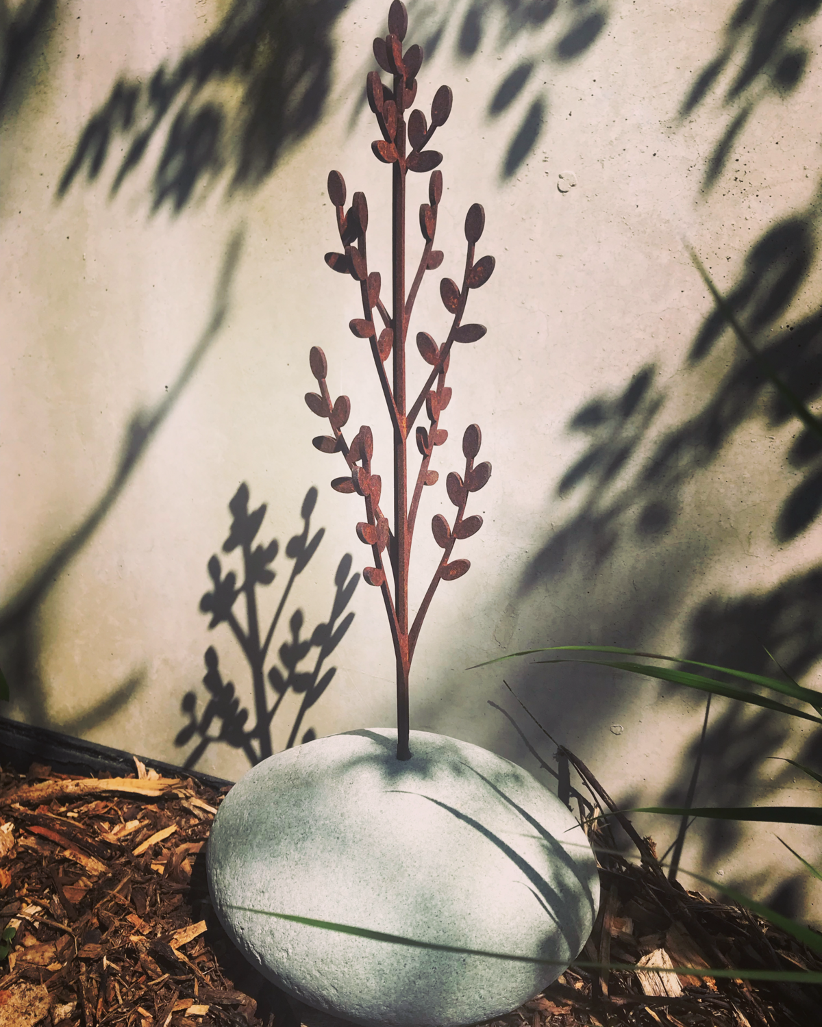Toitiiti Botanical Sculpture by Grounded Art NZ. Corten steel garden art. Beautiful delicate design in a natural stone base. 