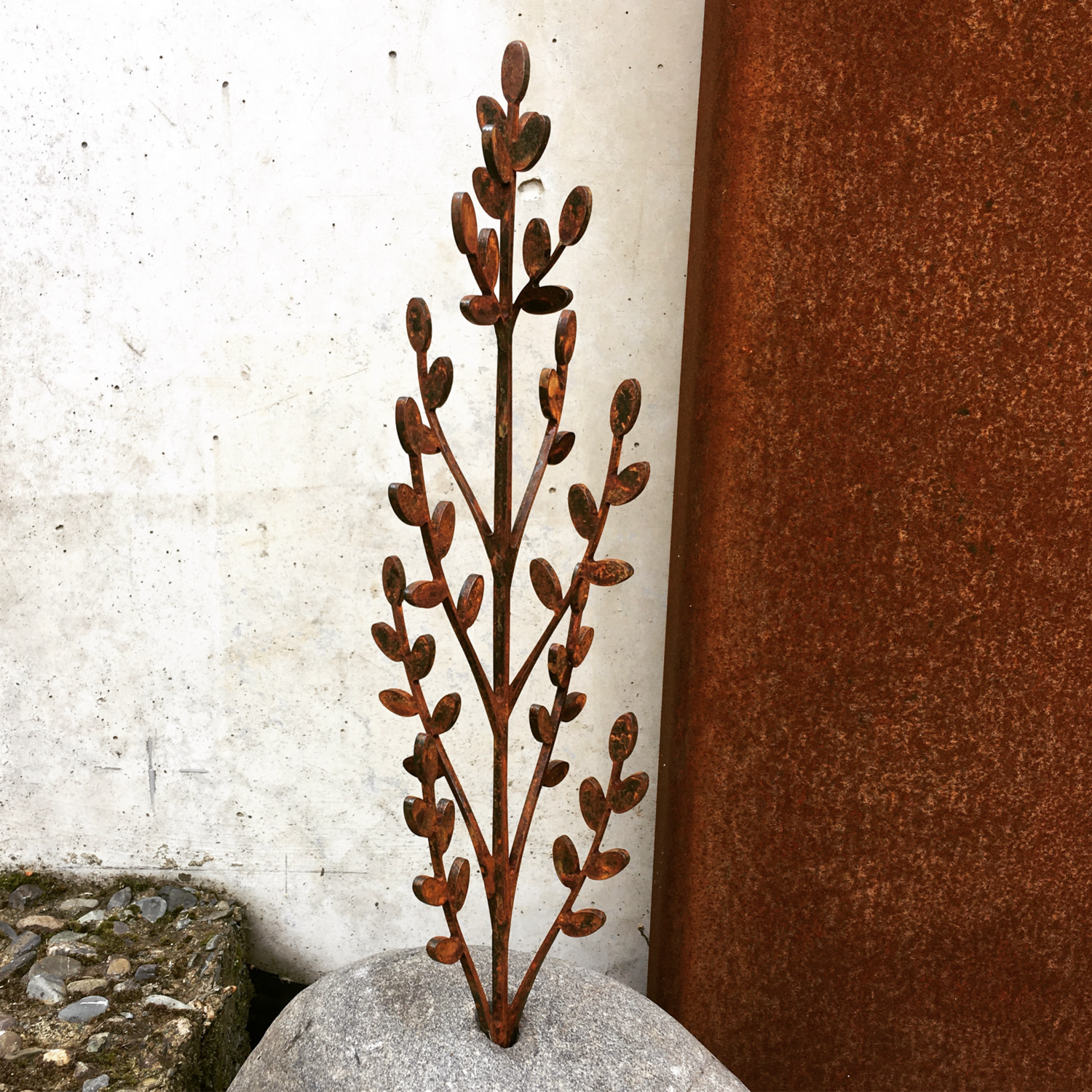 Toitiiti Botanical Sculpture by Grounded Art NZ. Corten steel garden art. Beautiful delicate design in a natural stone base. 