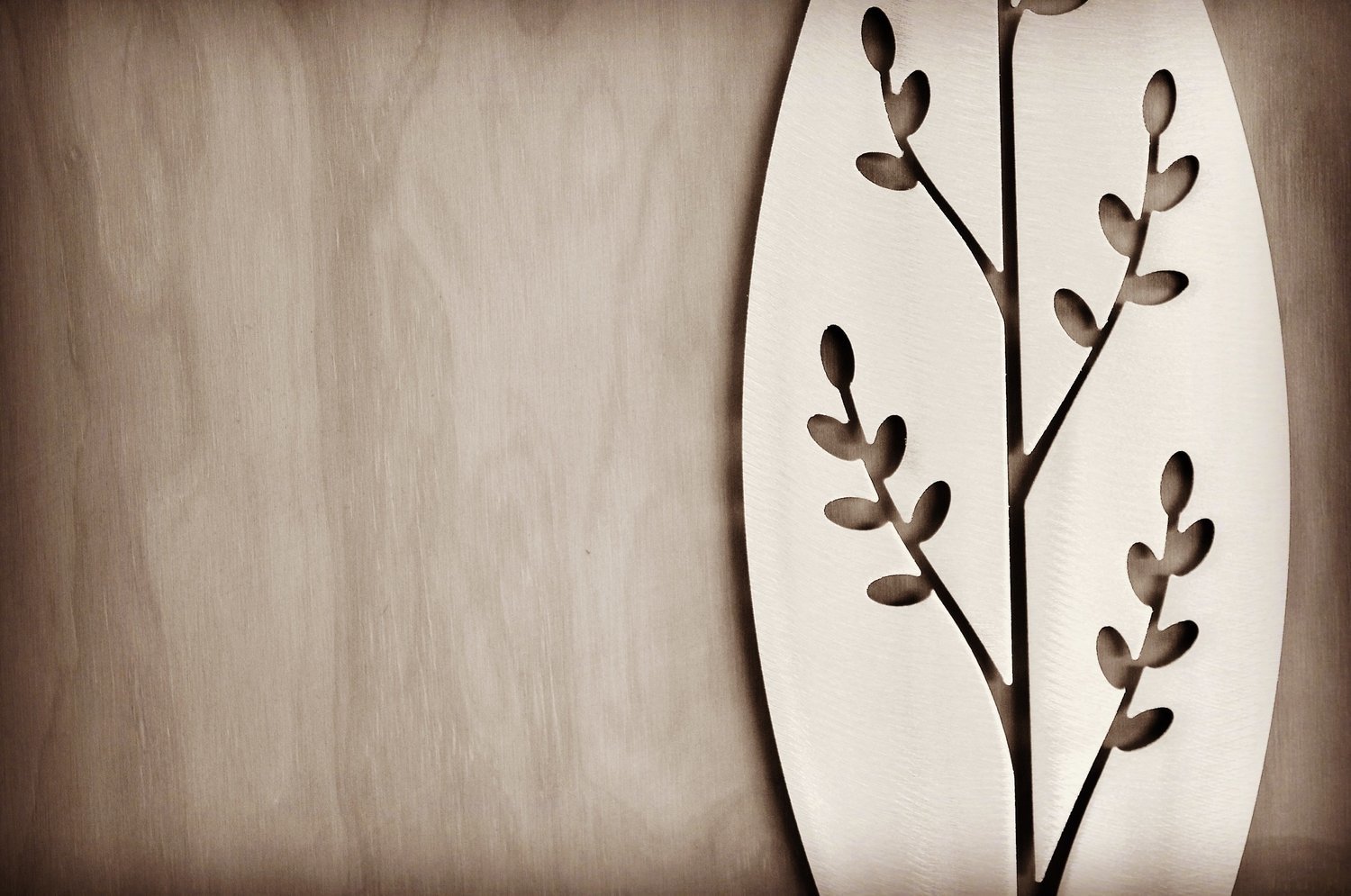 detail of the Korokio Aluminium Spear design by Grounded Art NZ in a gallery with the pale plywood wall behind.