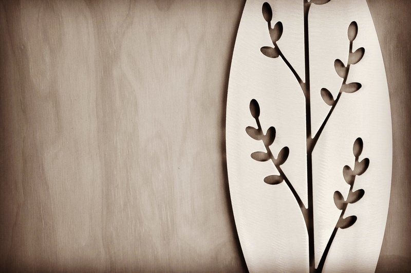 detail of the Korokio Aluminium Spear design by Grounded Art NZ in a gallery with the pale plywood wall behind.