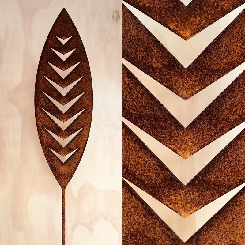 Corten Arrow Spear by Grounded Art NZ, in South Otago New Zealand. Rusty Corten patina against a plywood wall in a gallery.