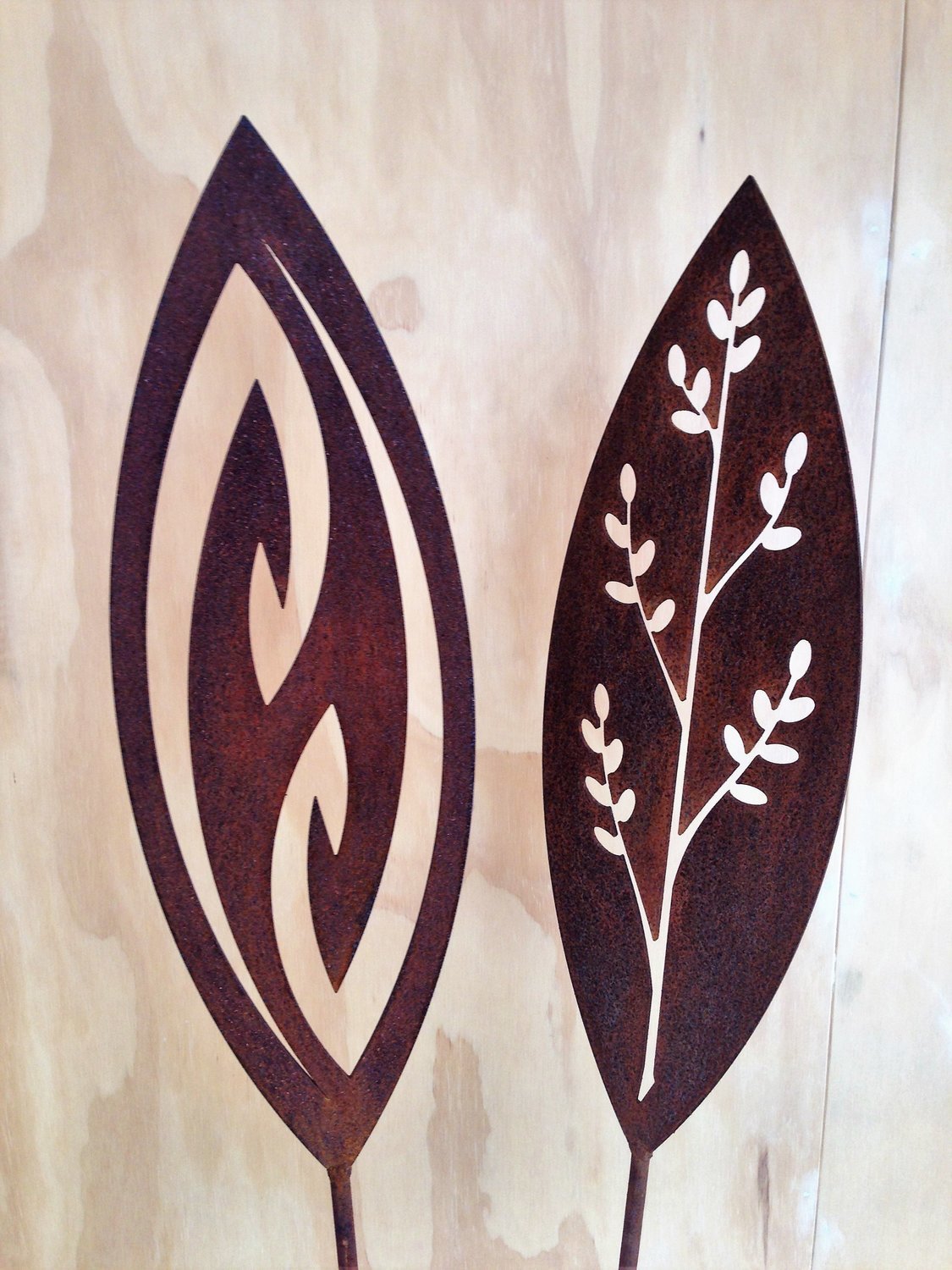Fish Hook and Korokio Corten Spears by Grounded Art NZ. 2 examples of popular metal garden art in a gallery setting.
