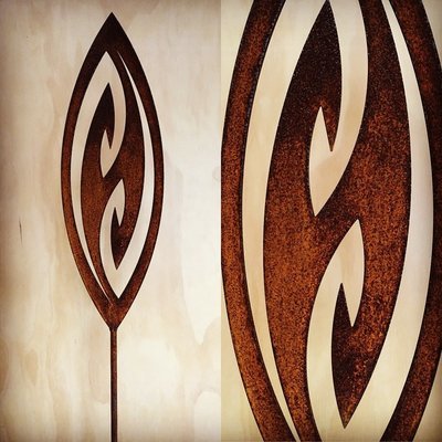 Corten garden spear in Fish Hook design by Grounded Art NZ in a gallery setting