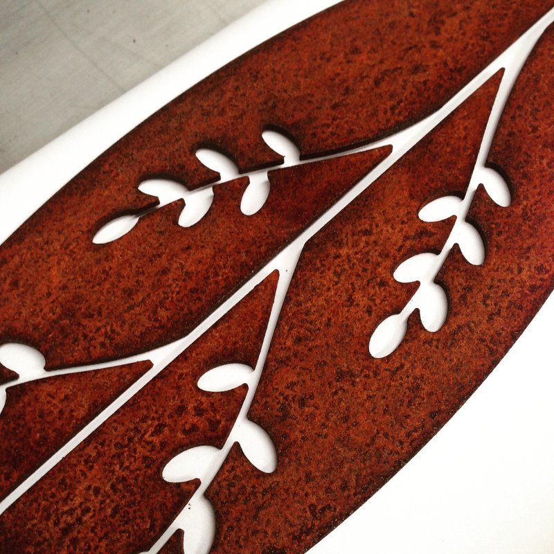 Corten Spear in Korokio design by Grounded Art NZ. Korokio detail in rusty Corten patina with a pale white background.