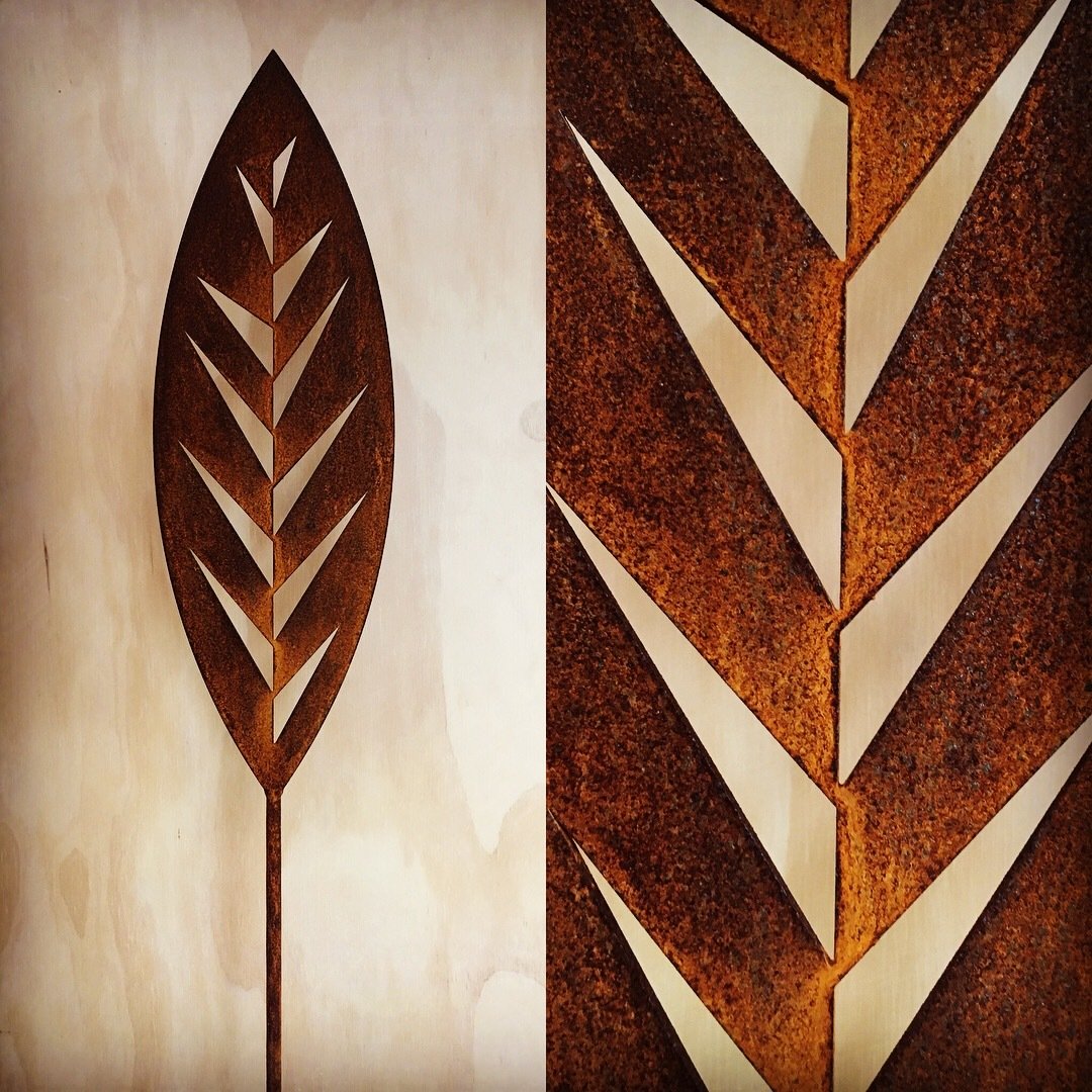 Rusty Leaf Corten Spear by Grounded Art NZ in a gallery setting. Bright glow of the rusty patina against a light background.