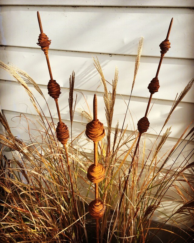 3 Rusty Kakano nestled in seedpods Native NZ grasses. Autumnal tones and texture captured by Grounded Art NZ wire garden art