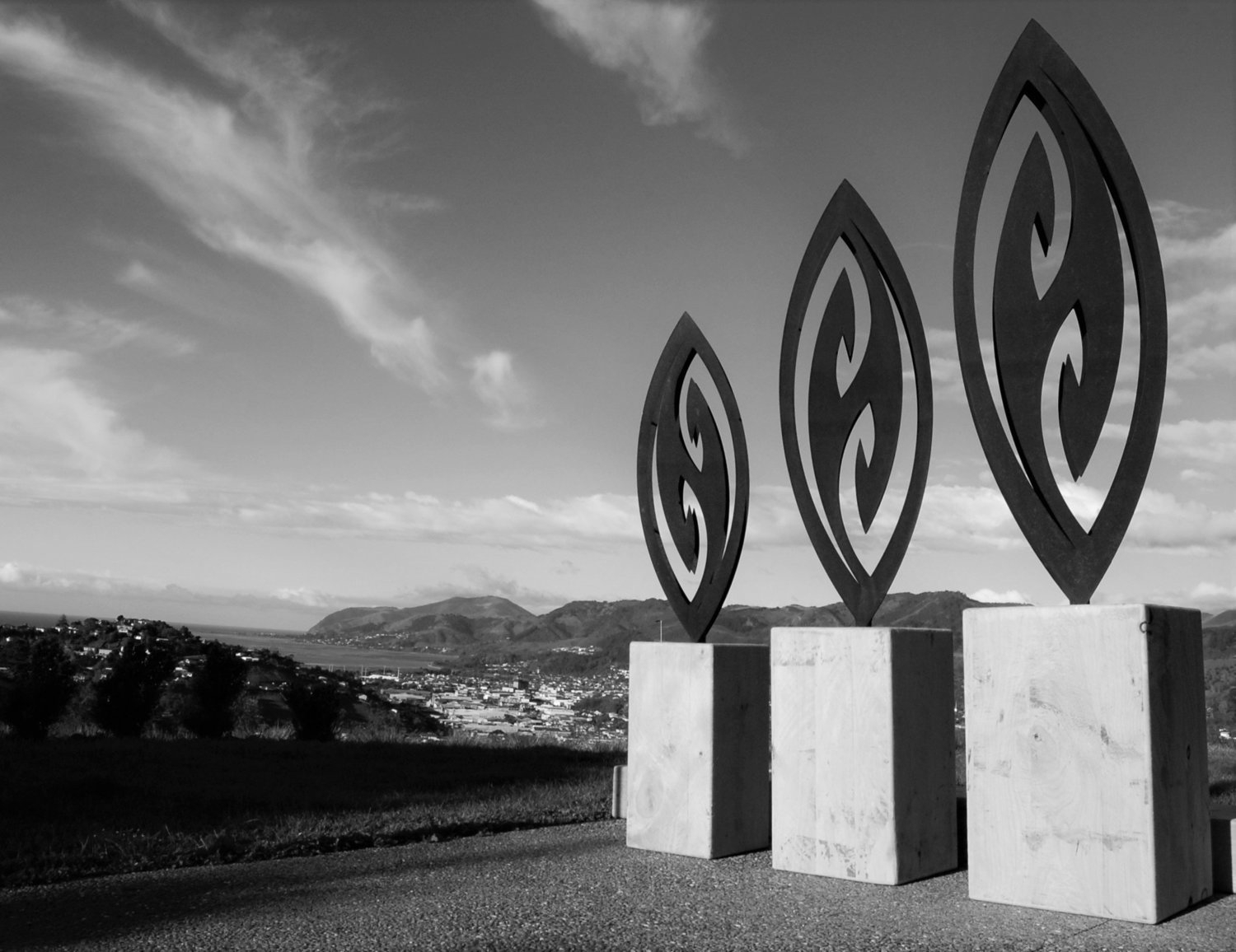 3 Corten Fish Hook Sculptures by Grounded Art NZ in wooden bases. Turn you garden into a gallery with our NZ made garden art.