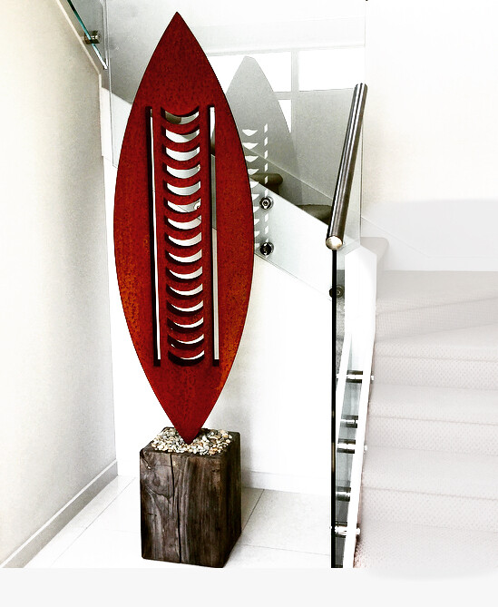 Large Rusted Corten Nikau Sculpture in a modern white entrance hall of a NZ home. 3D metal art by Grounded Art NZ.