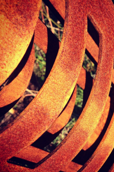 Close up of rusty detail and rings from a 3d Corten Nikau Sculpture made by Grounded Art NZ in Otago NZ.