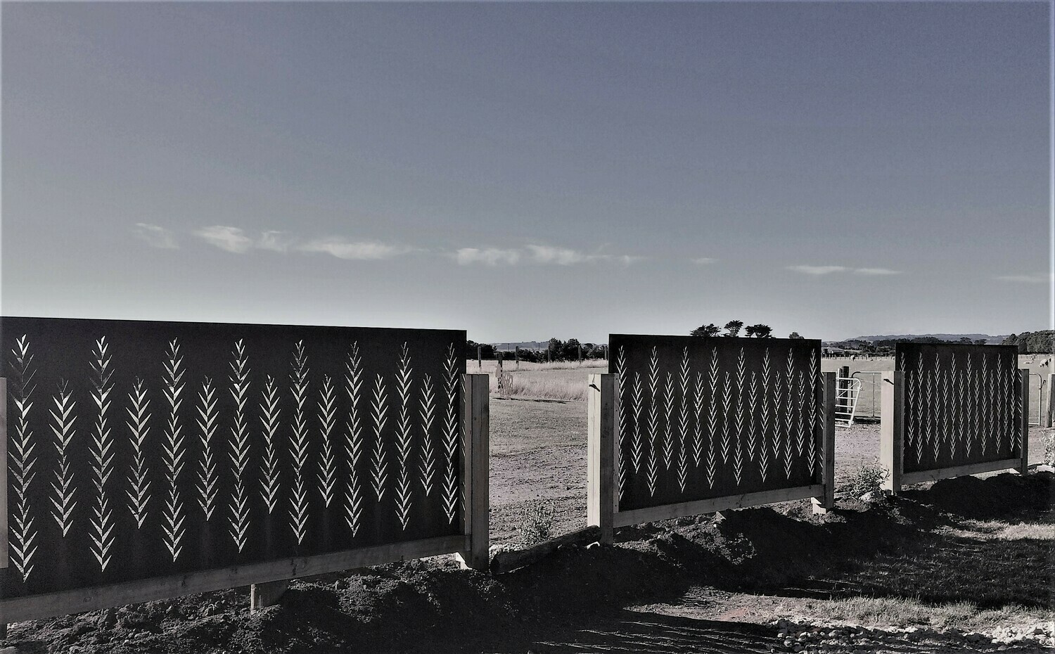 2 large Corten Leaf Screens by Grounded Art NZ in wooden frames. Dividing up a large open landscape and protection from wind.