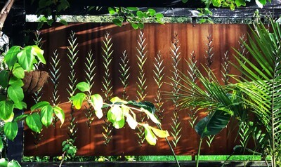 Rusty Patina Corten Leaf screen by Grounded Art NZ in a lush tropical garden setting.