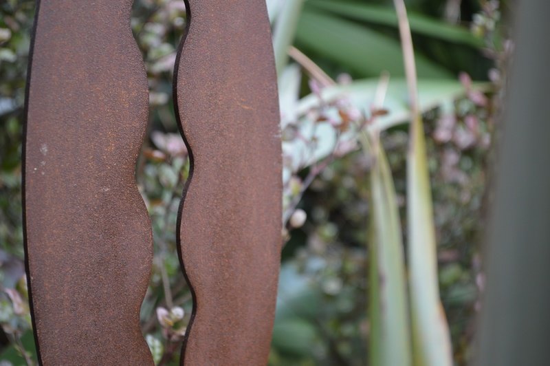 Rusty Kowhai Metal Garden Art. Corten Spear by Grounded Art NZ in a lush native NZ garden setting.