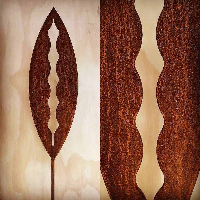 Rusty Kowhai Corten Spear by Grounded Art NZ in a gallery setting. Brilliance of the rusty patina against a light background.