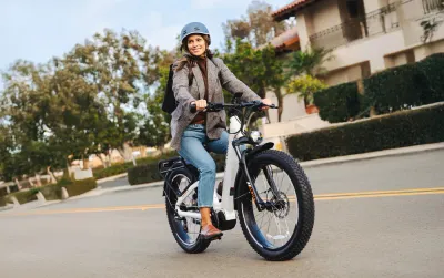 A woman riding a Heybike Alpha Ebike in White