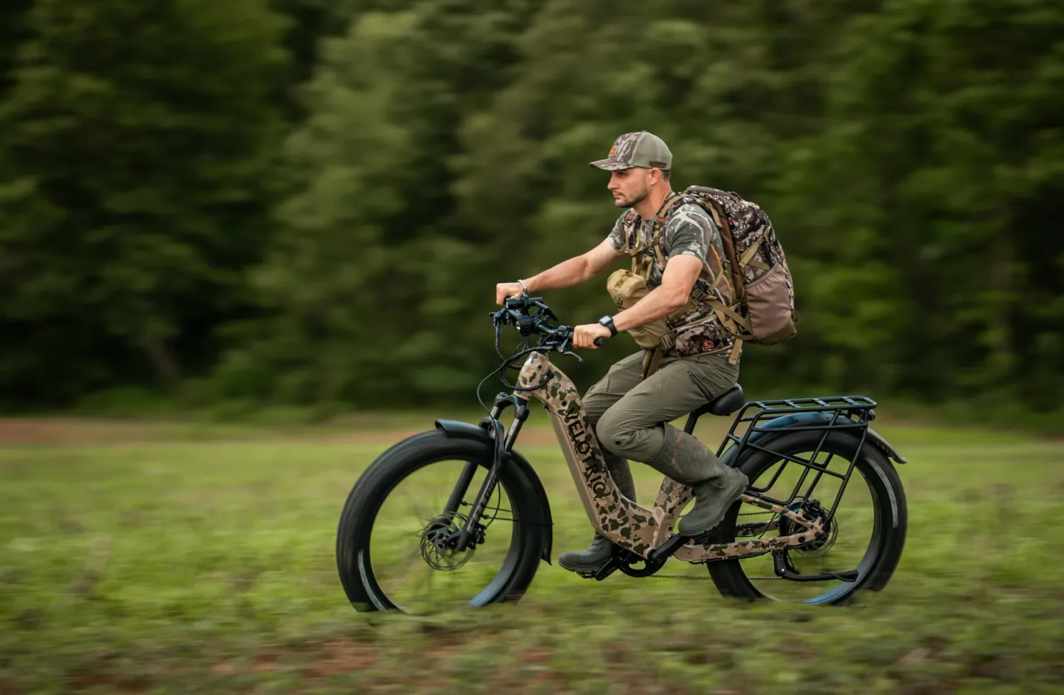 Man riding his Velotric Nomad 2X Step-Thru in Camo