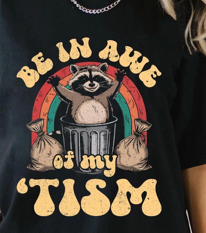 Be In Awe of My ’Tism Tee 🦝🌈💛