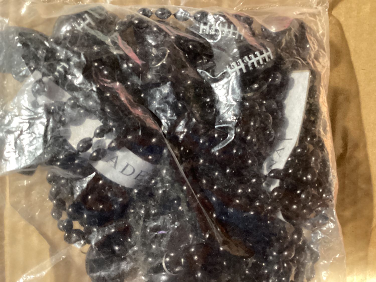 33&quot; 6 x 9mm Oval Black Bead with Football Pendant (Dozen)