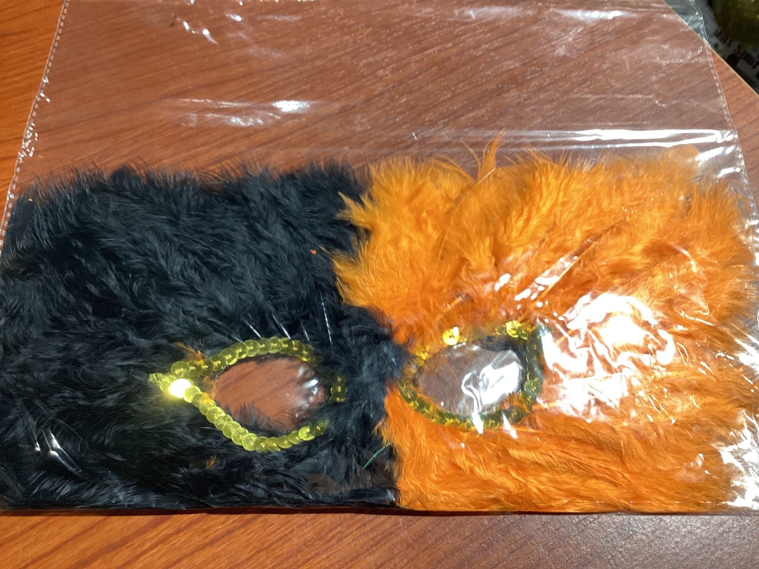 Black and Orange Feather Mask with Gold Sequins Around Eyes