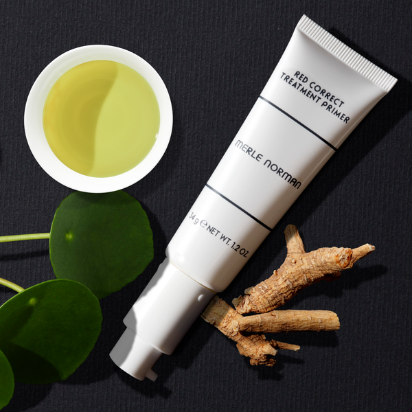 Merle Norman Red Correct Treatment Primer bottle on a white background. 