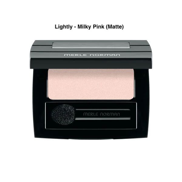Merle Norman Soft Touch Eye Shadow in the Lightly - Milky Pink Matte shade on a white background with case slightly opened. 
