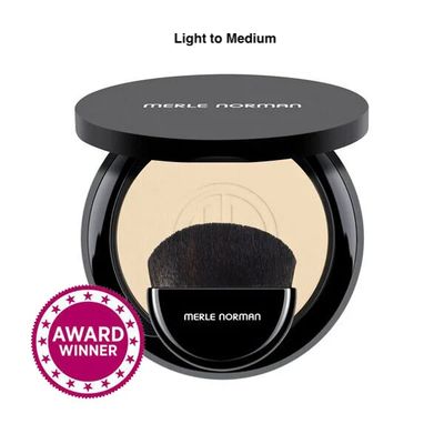 Merle Norman Soft-Focus Finishing Powder in Light to Medium Shade, slightyl opened tro show color and makeup brush. 