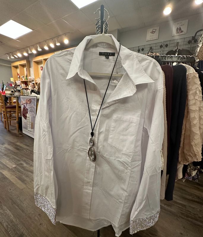FORE White Long-Sleeve Button-Down Blouse with Shimmering Sleeves with a necklace over it Merle Norman Elizabethton's Shop.