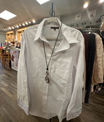 FORE White Long-Sleeve Button-Down Blouse with Shimmering Sleeves with a necklace over it Merle Norman Elizabethton's Shop.