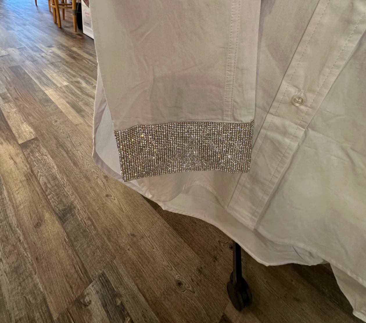 FORE White Long-Sleeve Button-Down Blouse with Shimmering Sleeves with a necklace over it Merle Norman Elizabethton's Shop.