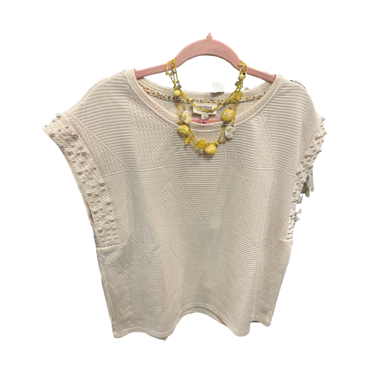 Umgee Ladies Sleeveless Pearl Blouse on a rack at Merle Norman Elizabethton. 